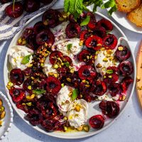 burrata with crushed cherries and pistachios